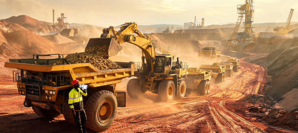 Wheel loader is loading gold ore into heavy-duty dump truck